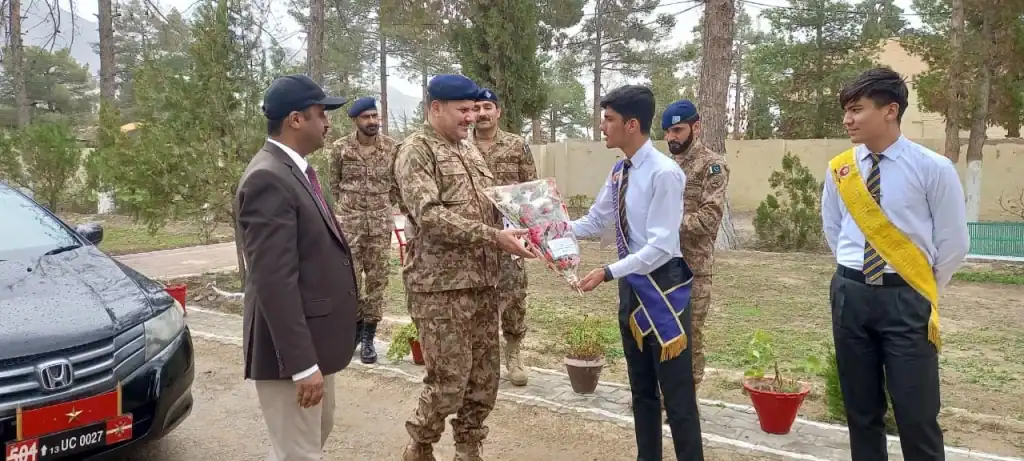 FGBDC Quetta students presenting flowers to military officials during a ceremonial event at the educational institute.