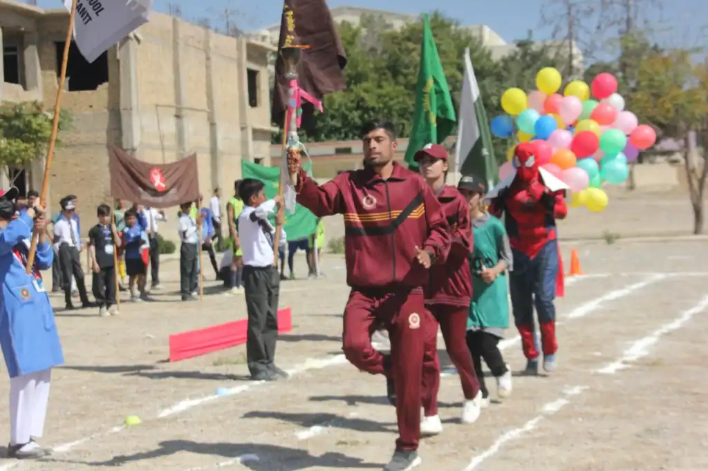 FGBDC Quetta school students participating in a cultural and sports event with flags, balloons, and students in uniform, showcasing school pride and extracurricular activities at FGBDC Quetta.