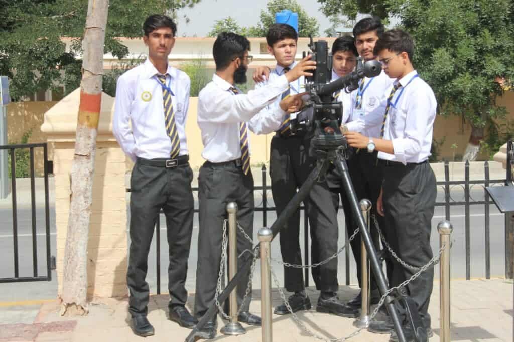 High school students at FGBDC Quetta engaging with a telescope for educational astronomy activities. Students in uniform are exploring space science in a learning environment.