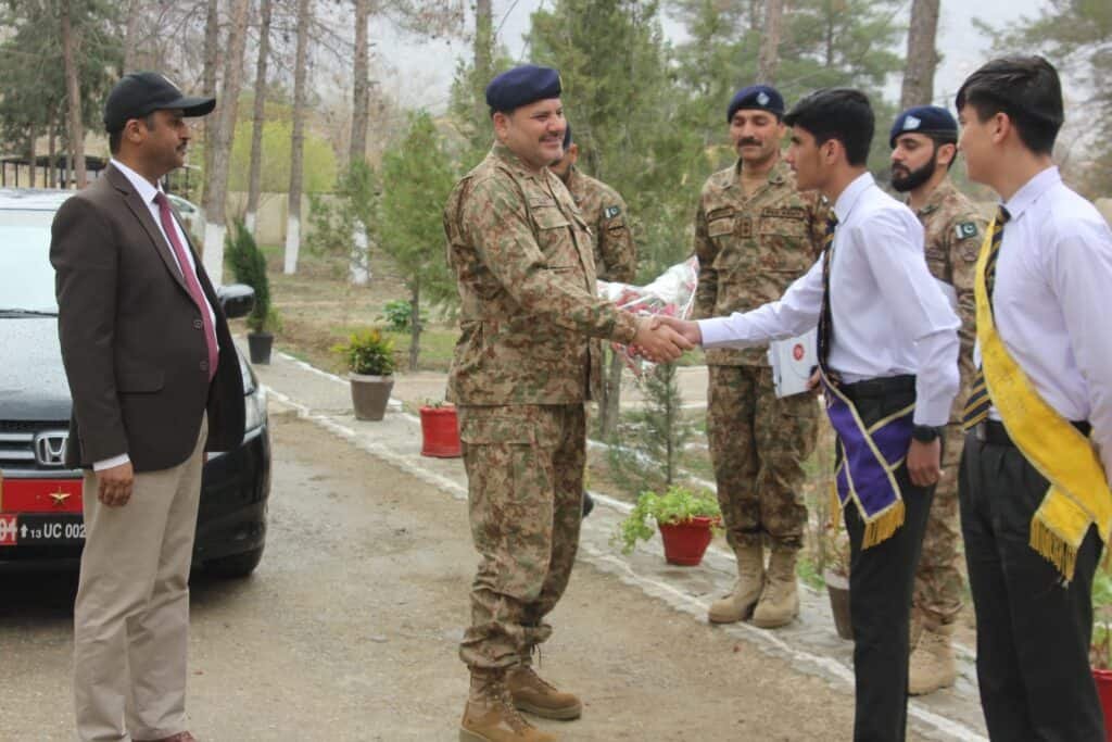 High-ranking military officer shaking hands with a young student at FGBDC Quetta, showcasing military-academic cooperation in Baluchistan, Pakistan.